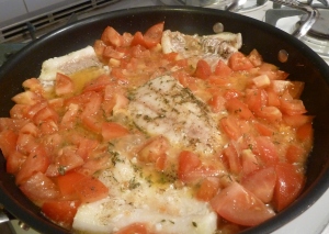 Cod with tomatoes in the pan